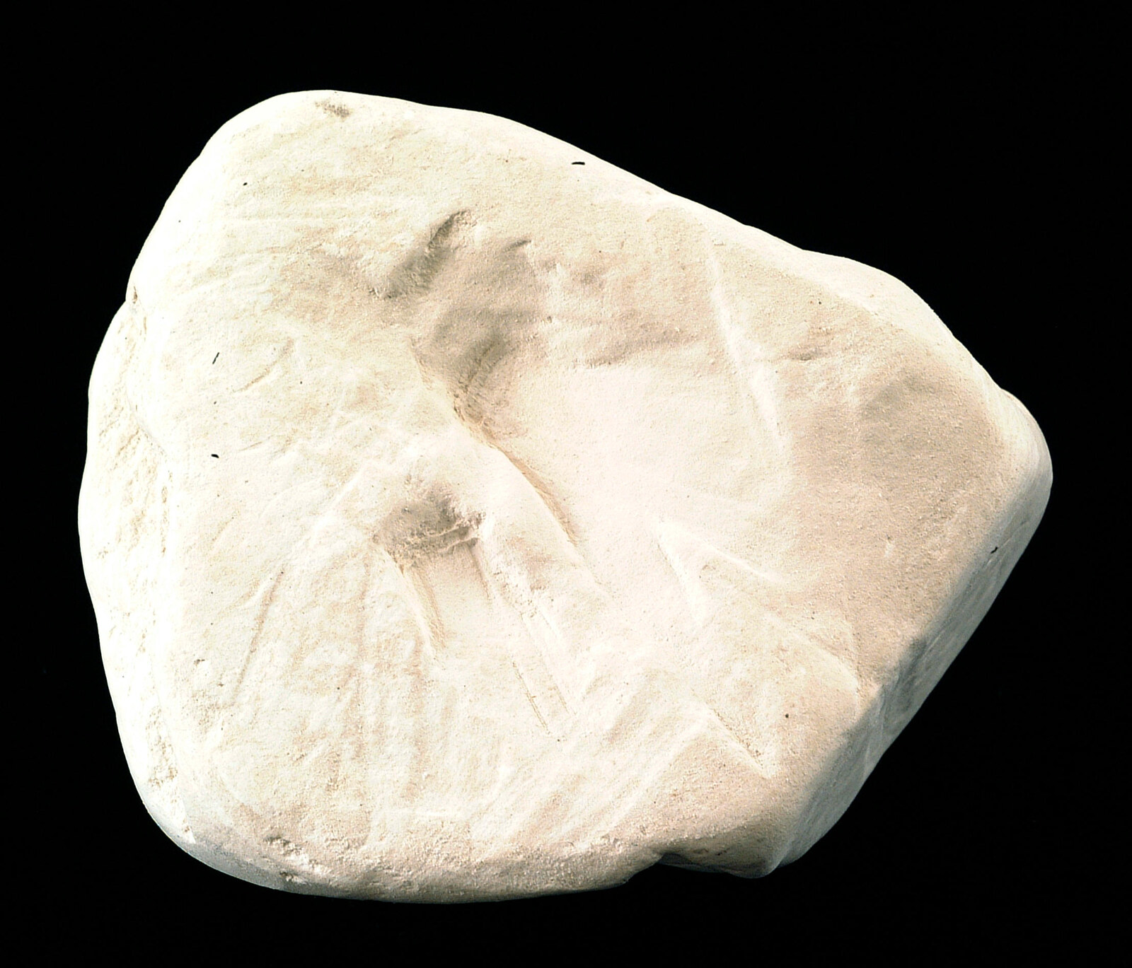 Pale kaolinite with a dull, uneven surface and no distinct reflected highlight.