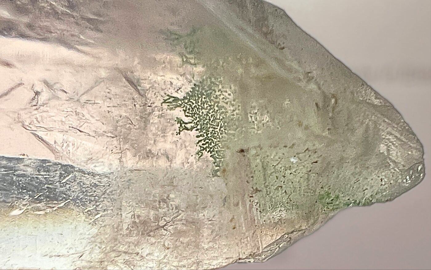 Green fuchsite phantom sealed inside a clear quartz point